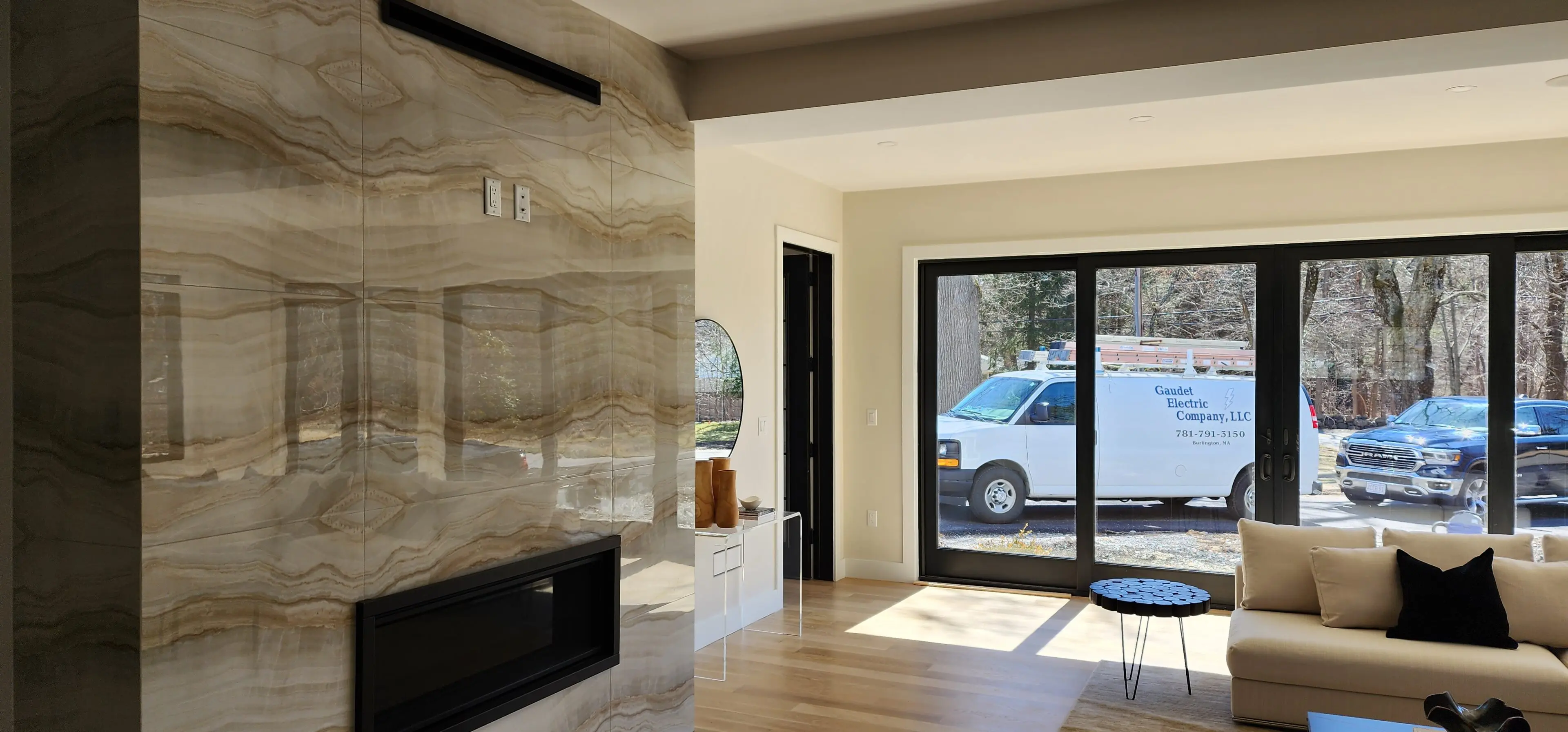 A living room with sliding glass doors and a fireplace.